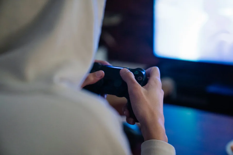 Manette de jeu posée devant un écran allumé